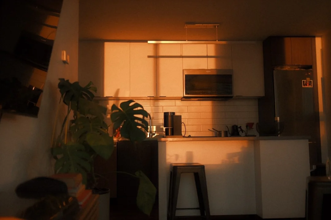 Kitchen illuminated by warm sunset light.